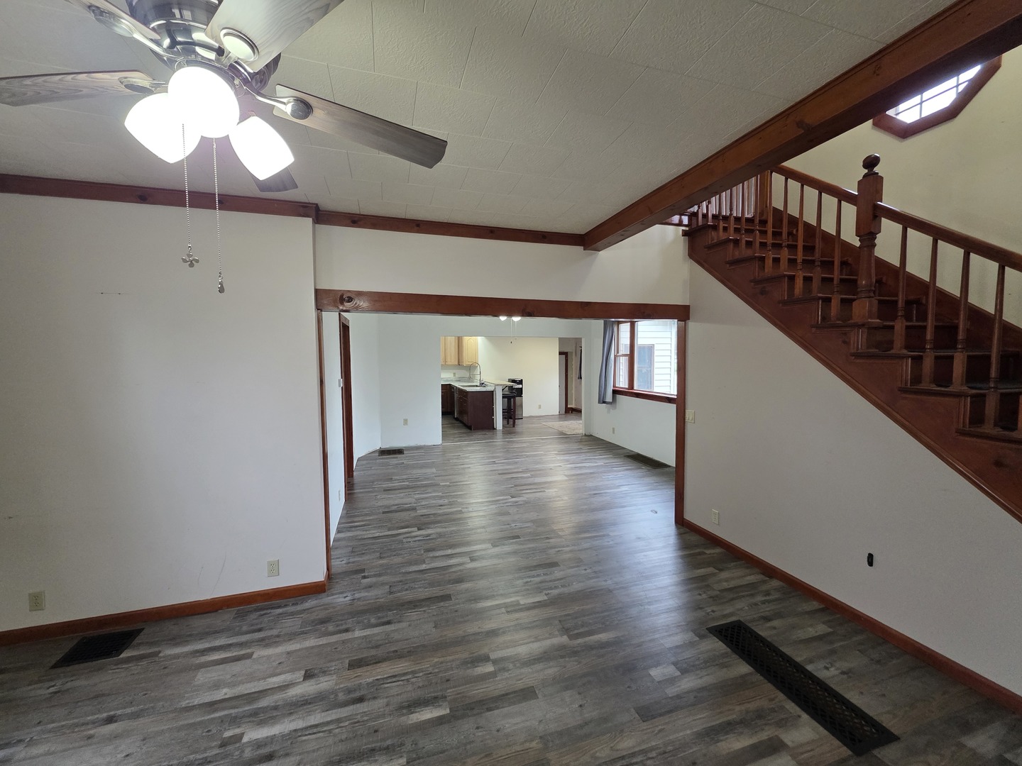 623 East Clay Street Clinton, IL 61727 - Photo 5 of 14 a view of empty room with wooden floor and fan