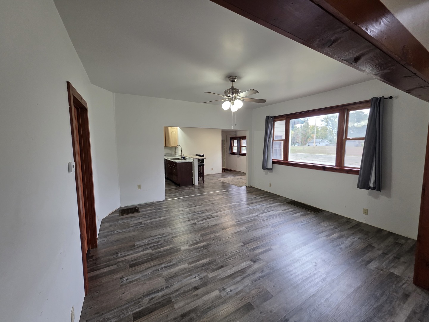 623 East Clay Street Clinton, IL 61727 - Photo 6 of 14 a view of empty room with wooden floor and fan