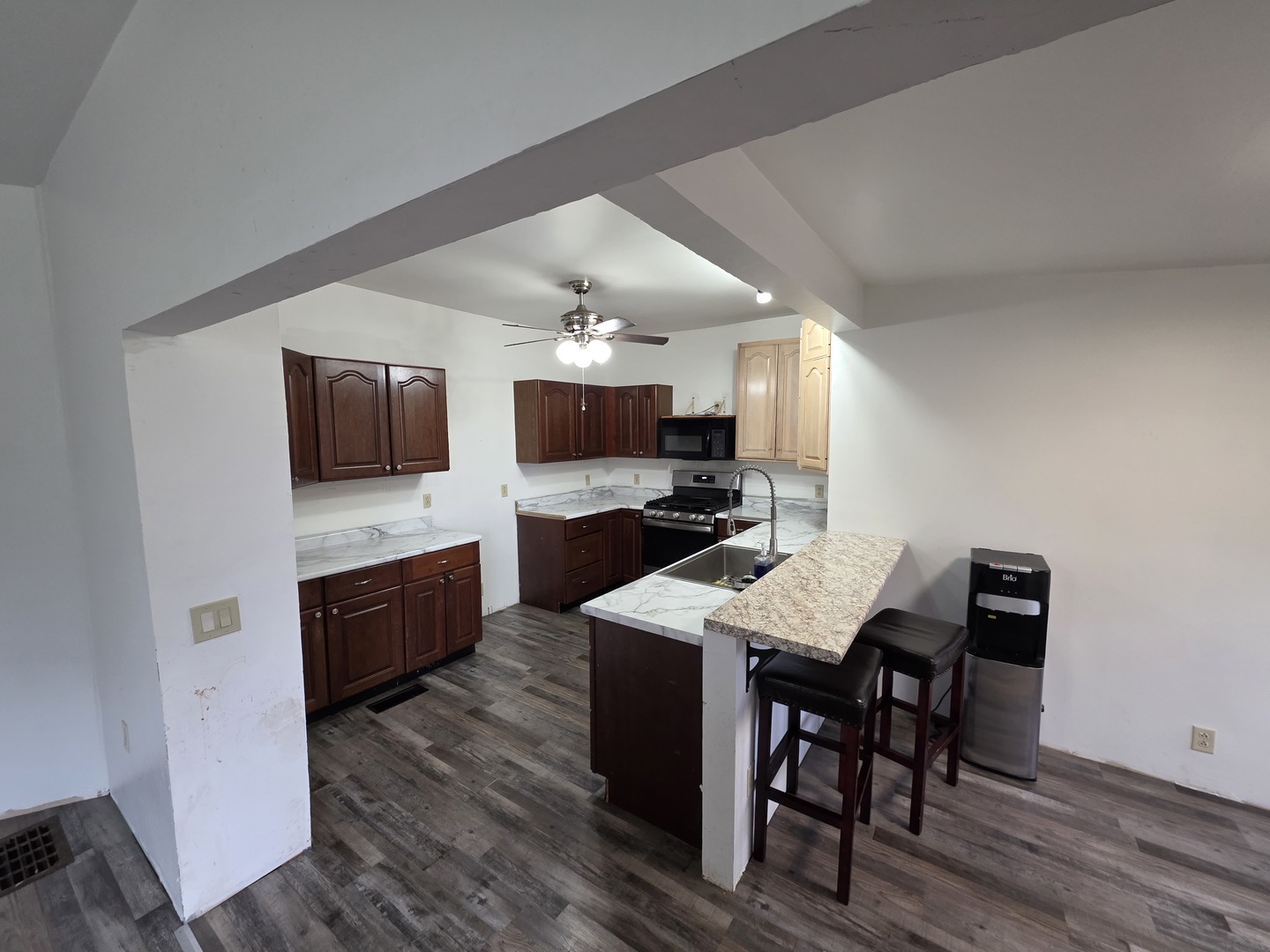 623 East Clay Street Clinton, IL 61727 - Photo 7 of 14 a large kitchen with a table and chairs in it