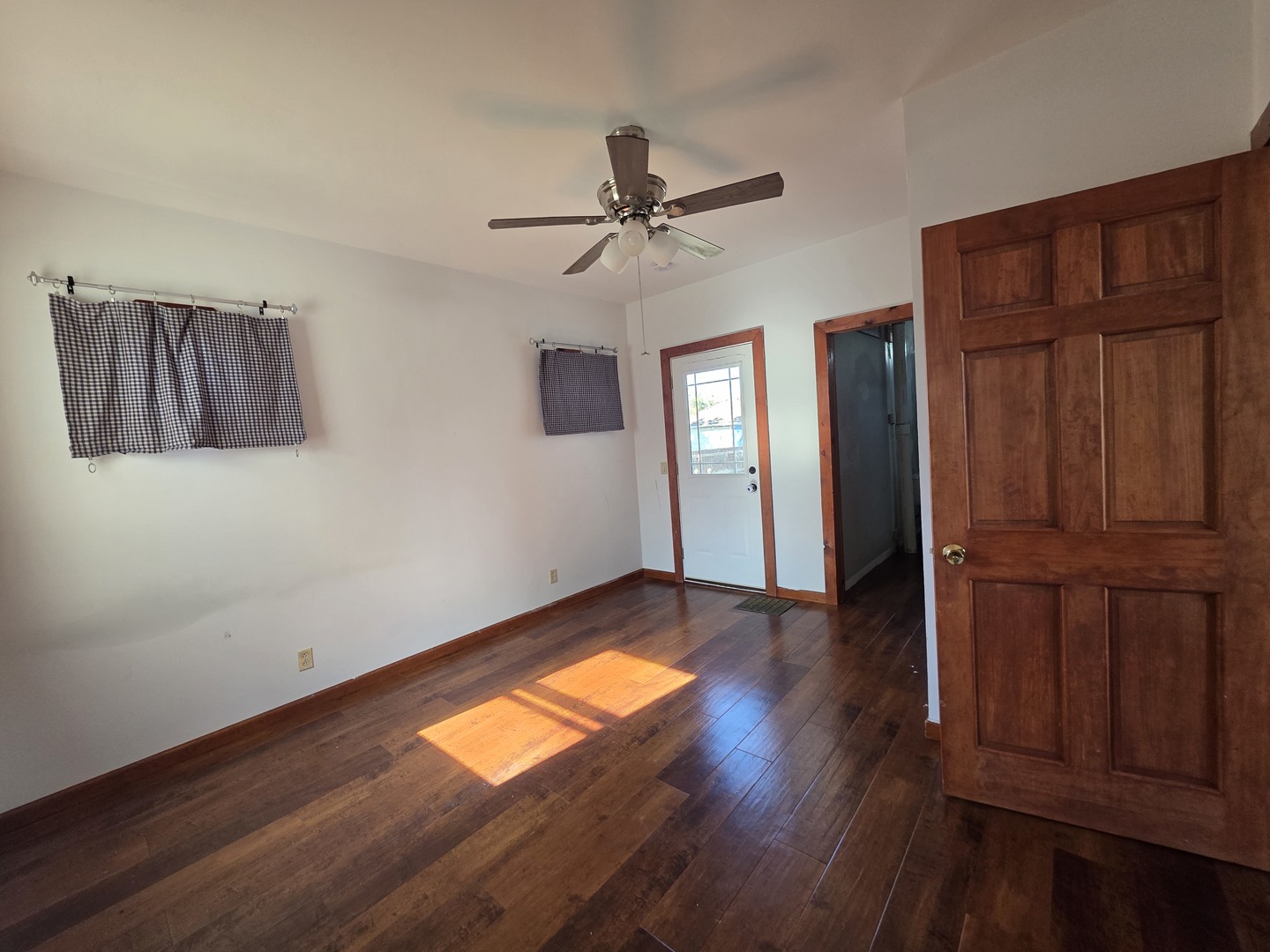 623 East Clay Street Clinton, IL 61727 - Photo 9 of 14 an empty room with wooden floor closet and windows