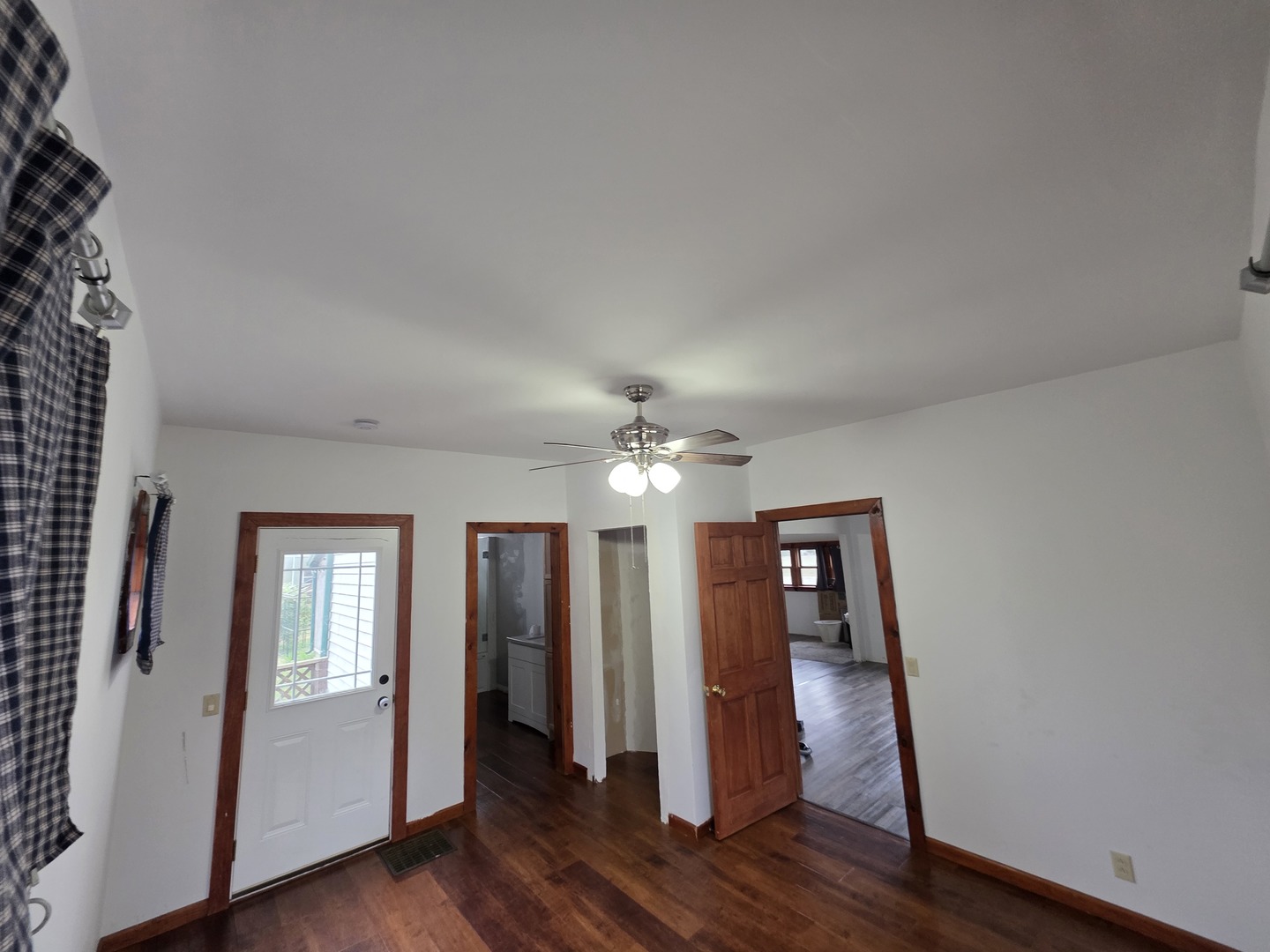 623 East Clay Street Clinton, IL 61727 - Photo 10 of 14 wooden floor in an empty room with a window