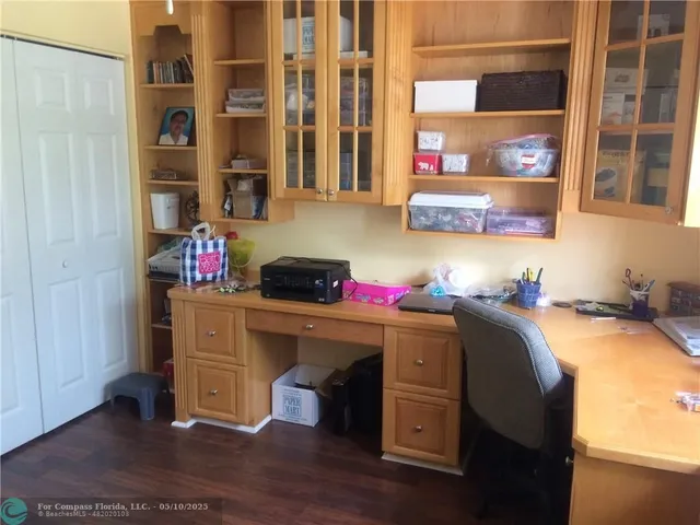 a room with a wooden floor and cabinets