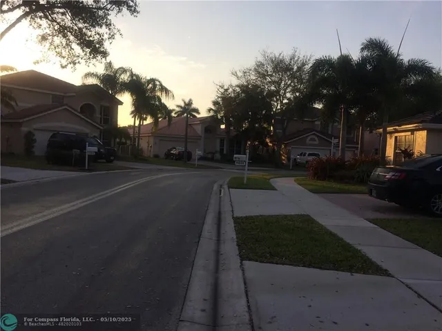a view of a street with houses on both side
