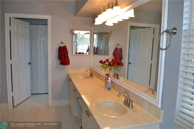 a bathroom with a sink vanity and mirror