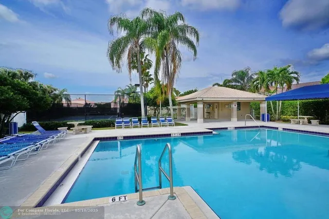 a view of a house with swimming pool and sitting area