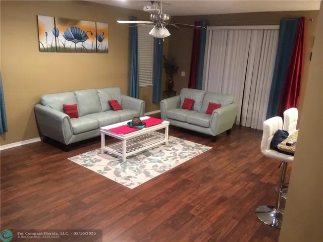 a living room with furniture and wooden floor