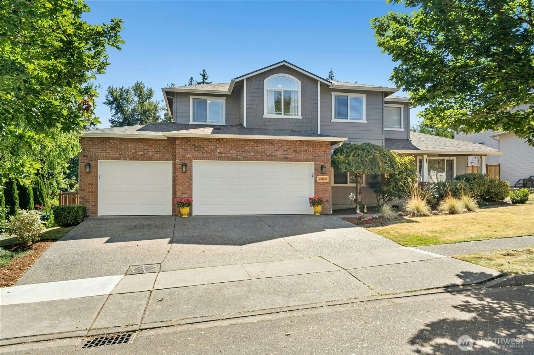 a front view of a house with a yard and garage