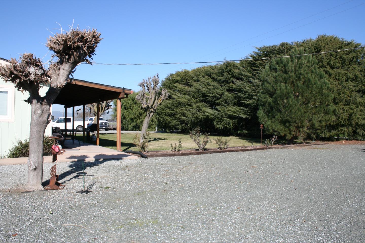 1738 H Santa Ana Road, Unit H Hollister, CA 95023 - Photo 16 of 33 a view of a patio with a table and chairs under an umbrella