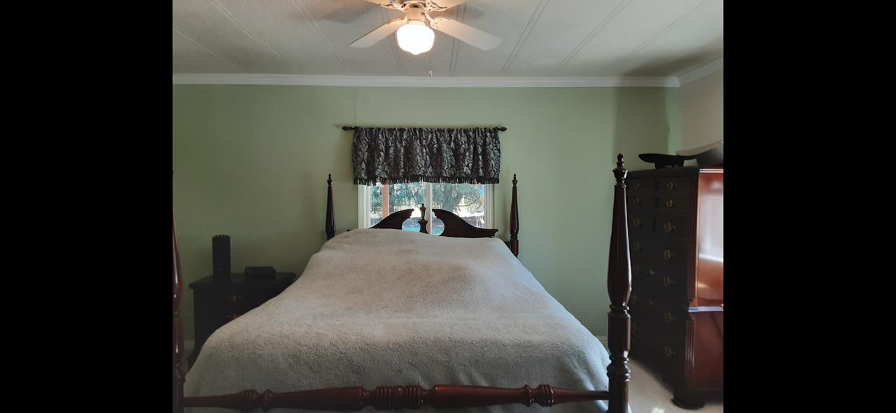 1738 H Santa Ana Road, Unit H Hollister, CA 95023 - Photo 26 of 33 a bed sitting in a bedroom next to a window