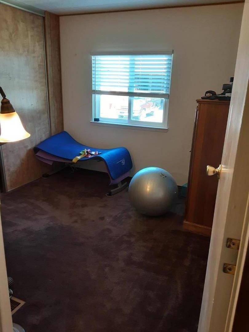 1738 H Santa Ana Road, Unit H Hollister, CA 95023 - Photo 29 of 33 a bedroom with a bed and a mirror