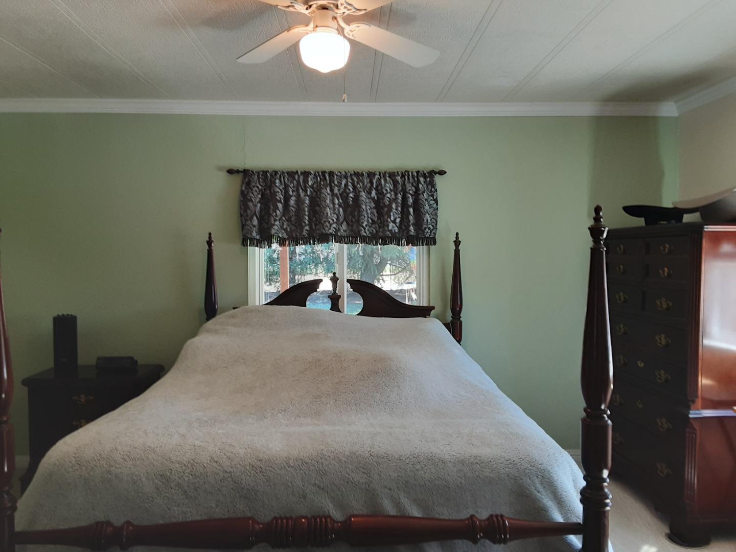 1738 H Santa Ana Road, Unit H Hollister, CA 95023 - Photo 33 of 33 a bed sitting in a bedroom next to a window