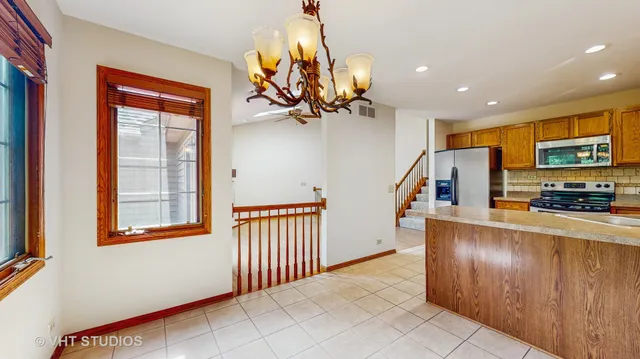 a view of an empty room with a fireplace and a window
