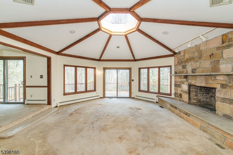 24 Wehrli Road Long Valley, NJ 07853 - Photo 2 of 16 a view of an empty room with a fireplace and a window