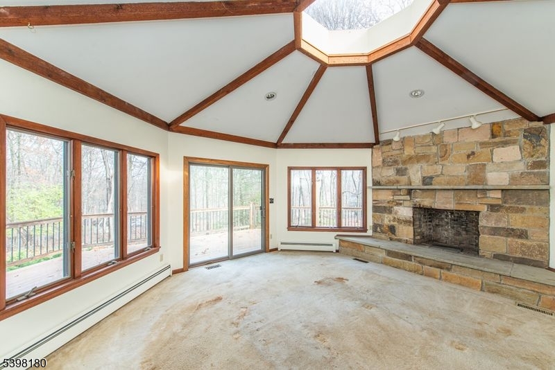 24 Wehrli Road Long Valley, NJ 07853 - Photo 3 of 16 a view of an empty room with a fireplace and a window