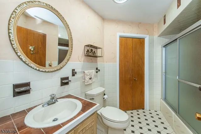 a bathroom with a sink a mirror and a toilet