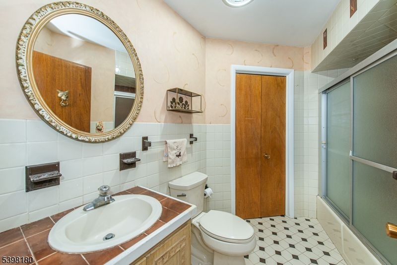 24 Wehrli Road Long Valley, NJ 07853 - Photo 5 of 16 a bathroom with a sink a mirror and a toilet