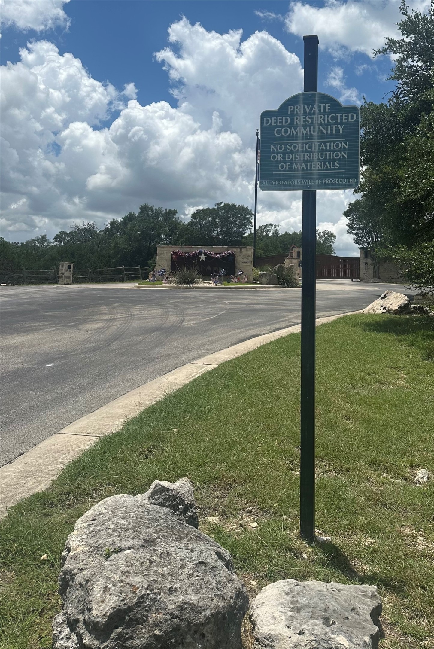 0 Lantana Gold Spring Branch, TX 78070 - Photo 14 of 15 Secure community entrance with an elegant stone wall, mature landscaping, and controlled access.