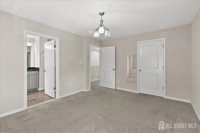 wooden floor in an empty room with a bathroom