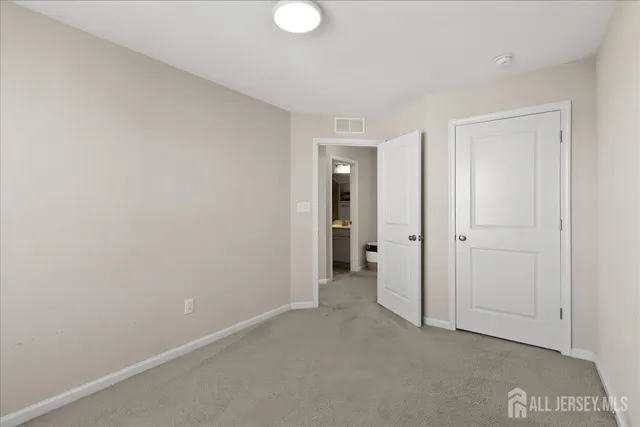 a view of an empty room and closet area