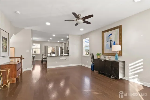 a living room with furniture and kitchen view