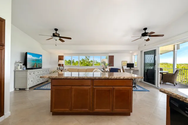 a room with a chandelier furniture and a flat screen tv