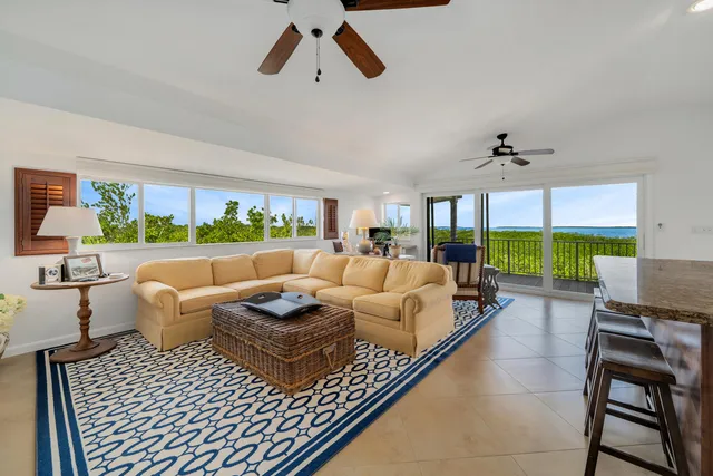 a living room with furniture fireplace and a large window