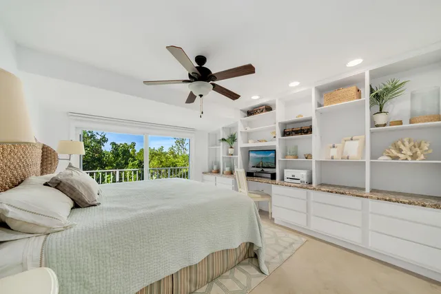 a bed room with a bed and a large window