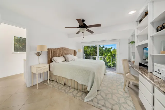 a spacious bedroom with a bed and a flat screen tv