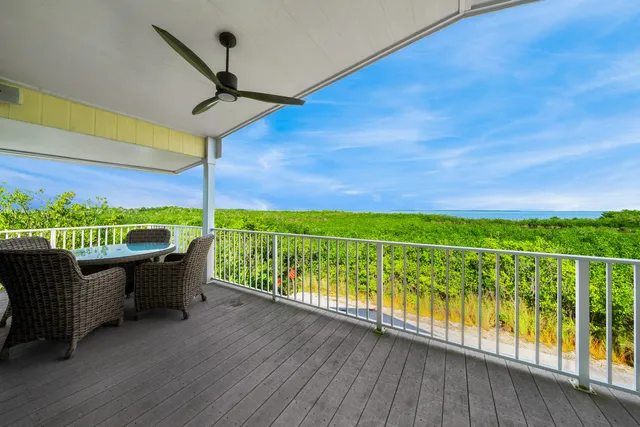 a view of a chairs and table in the balcony