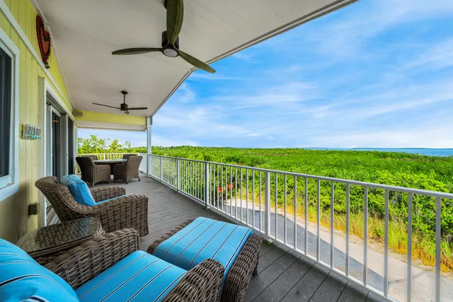 a balcony with furniture and wooden floor