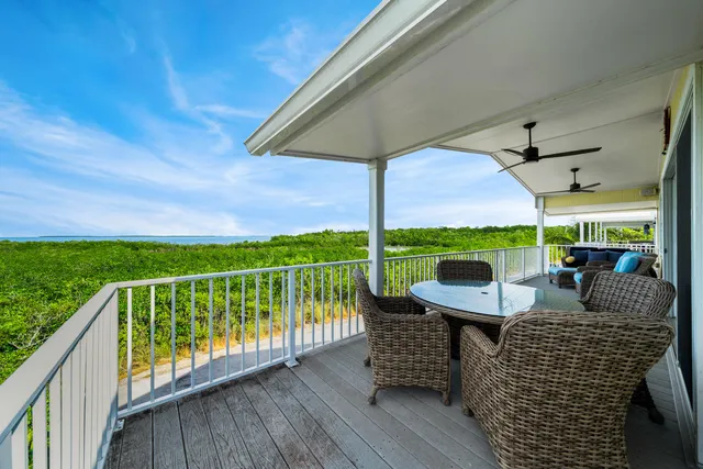 a view of a balcony with wooden floor and fence