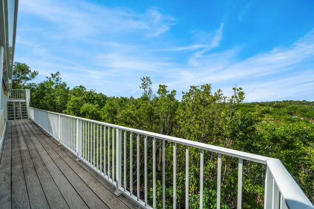a view of balcony with wooden floor