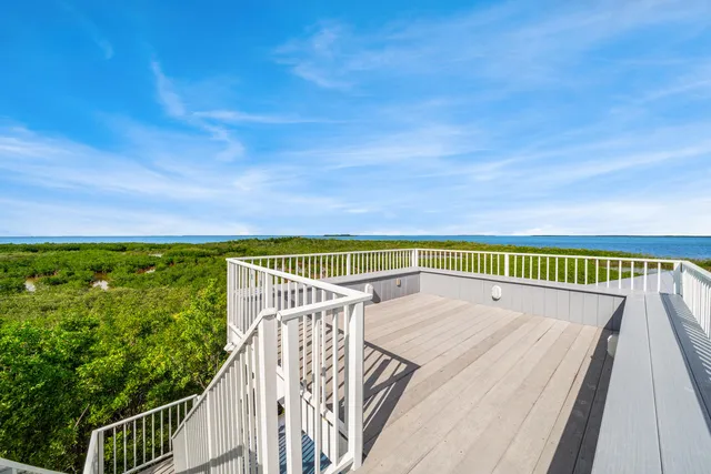 a view of a roof deck with wooden floor and fence