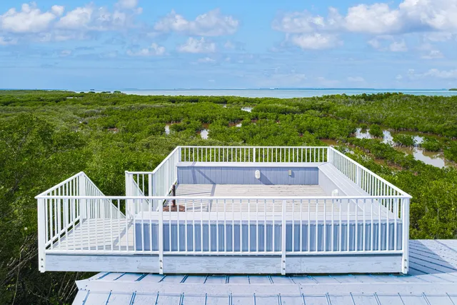 a view of a patio with table and chairs and potted plants