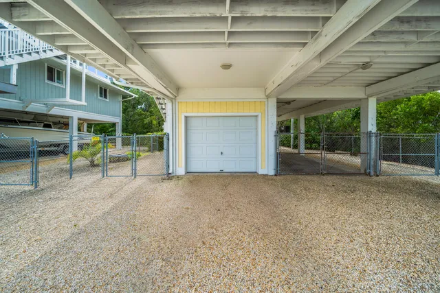 an aerial view of a house with garden space and ocean view