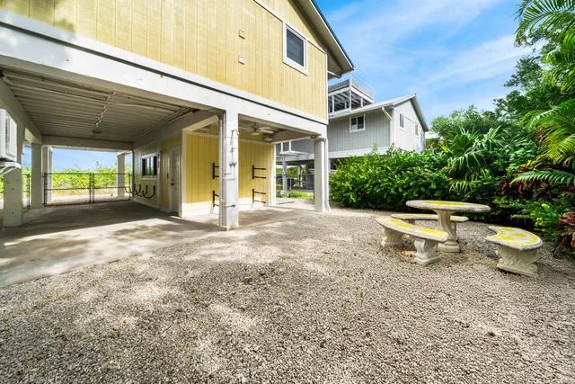 an aerial view of a house with garden space and street view