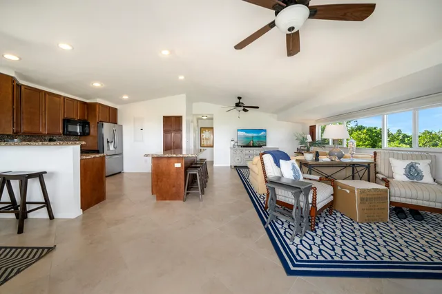 a dining room with furniture and a view of kitchen