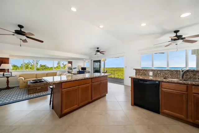 a kitchen with stainless steel appliances granite countertop a sink and a stove
