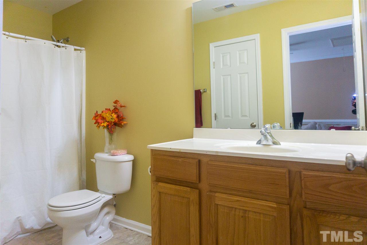 7029 Spanglers Spring Way Raleigh, NC 27610 - Photo 14 of 18 a bathroom with a sink and a toilet