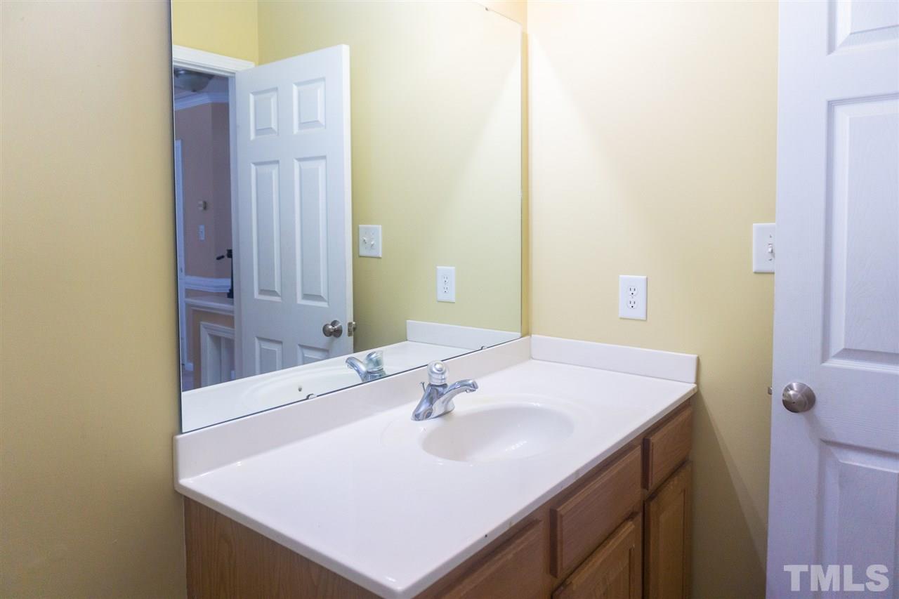 7029 Spanglers Spring Way Raleigh, NC 27610 - Photo 15 of 18 a bathroom with a sink and a mirror