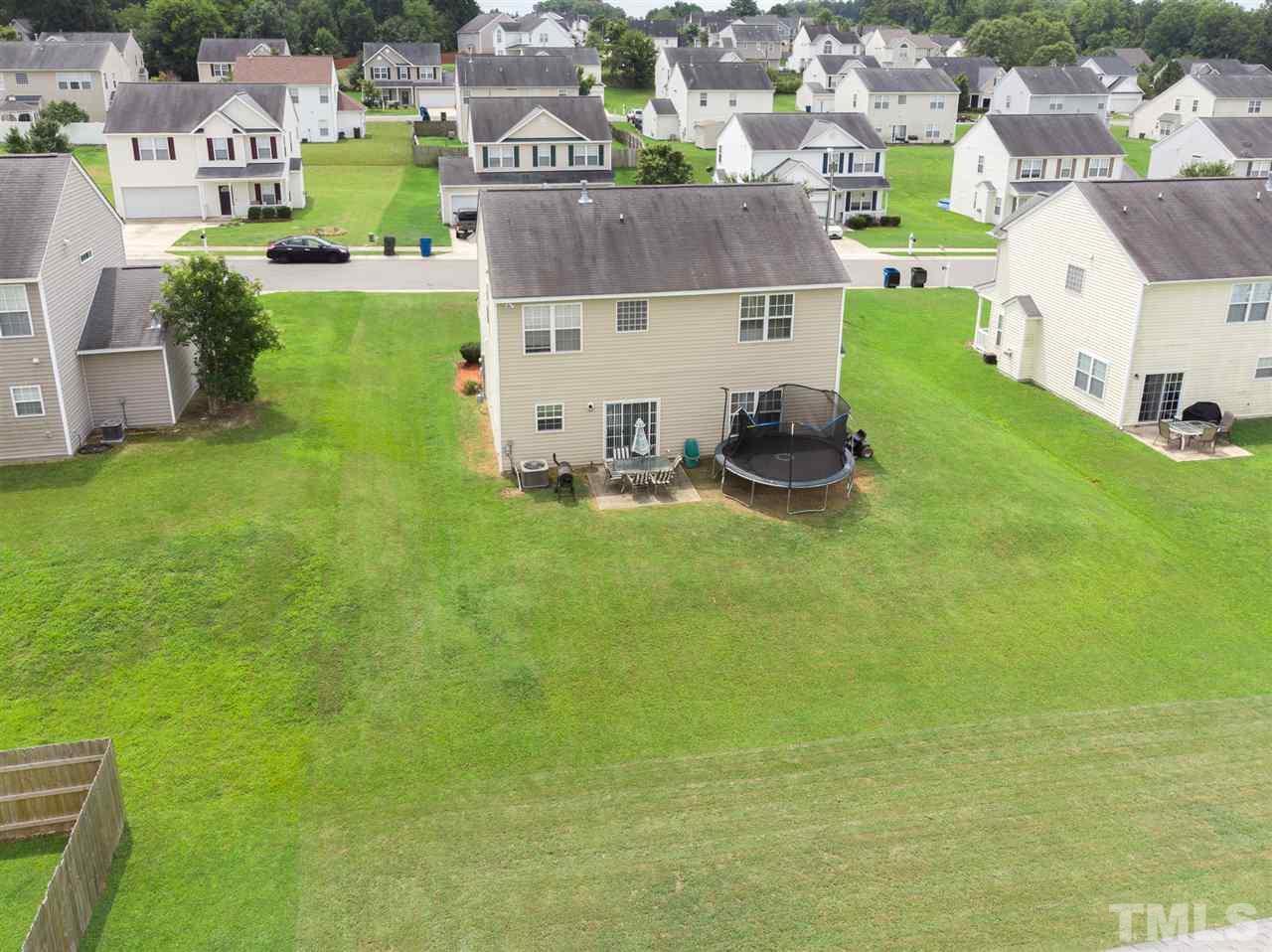 7029 Spanglers Spring Way Raleigh, NC 27610 - Photo 16 of 18 a view of a house with a yard