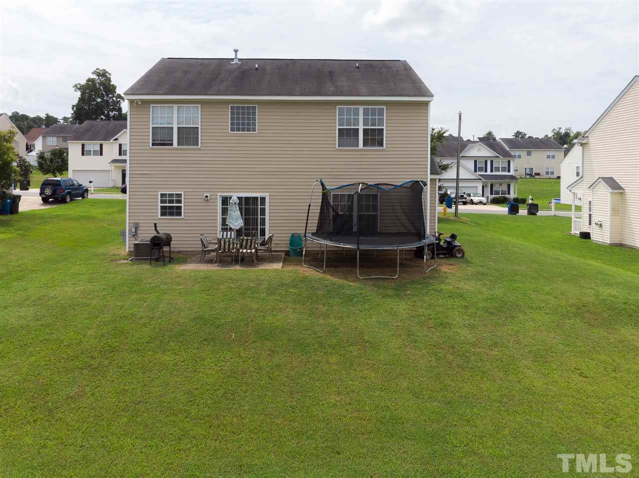 7029 Spanglers Spring Way Raleigh, NC 27610 - Photo 17 of 18 a house view with a garden space