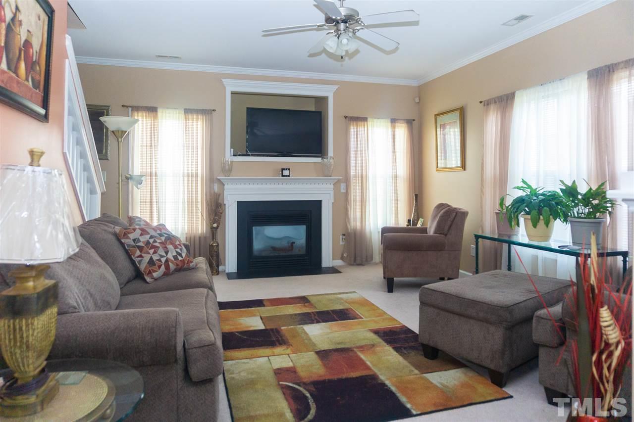 7029 Spanglers Spring Way Raleigh, NC 27610 - Photo 4 of 18 a living room with furniture fireplace and window