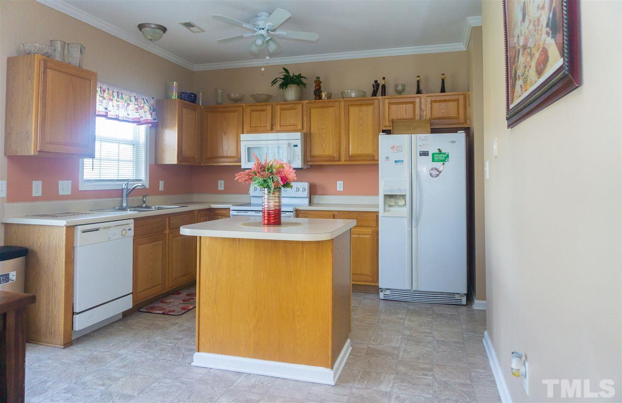 7029 Spanglers Spring Way Raleigh, NC 27610 - Photo 6 of 18 a kitchen with stainless steel appliances a sink stove and refrigerator