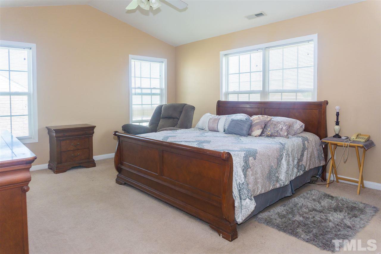 7029 Spanglers Spring Way Raleigh, NC 27610 - Photo 9 of 18 a bedroom with bed and window