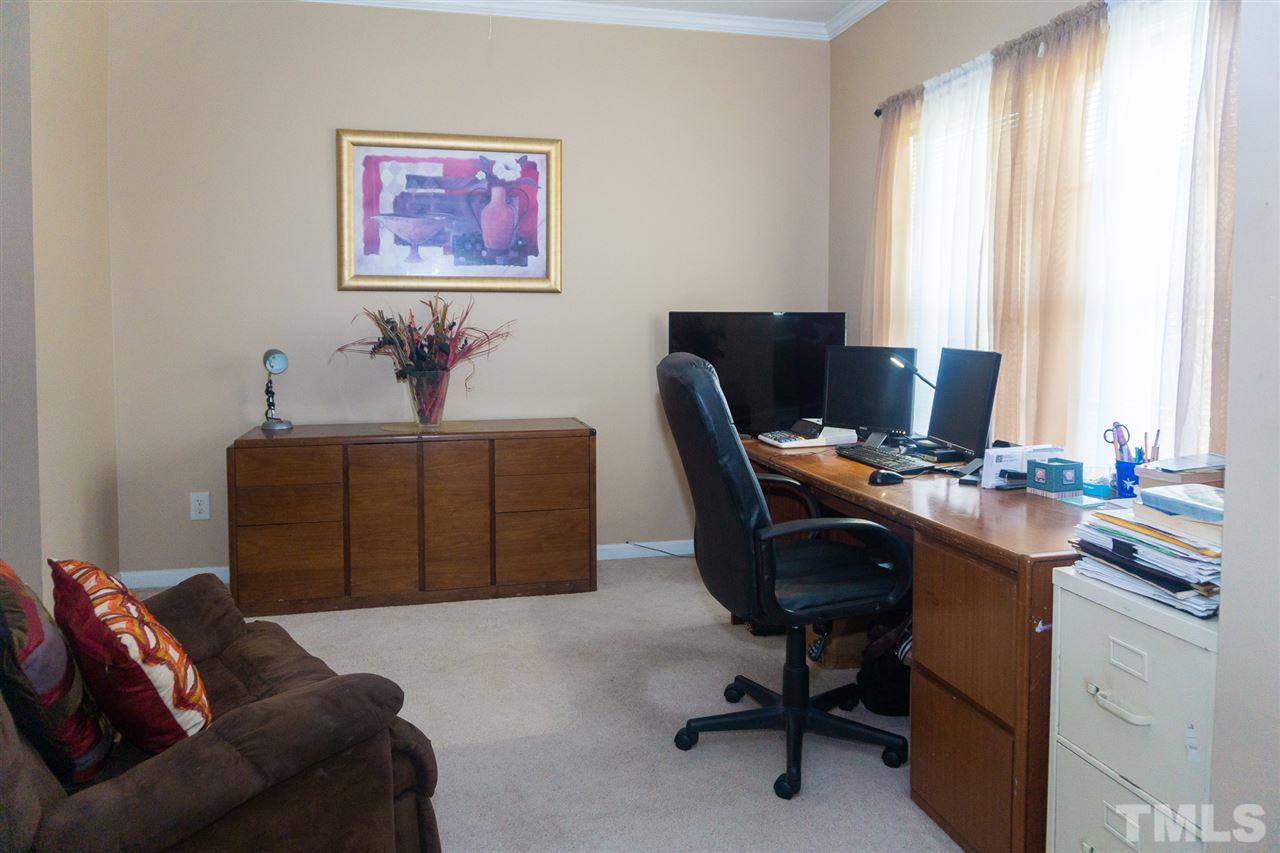 7029 Spanglers Spring Way Raleigh, NC 27610 - Photo 10 of 18 a view of a workspace with furniture and a window