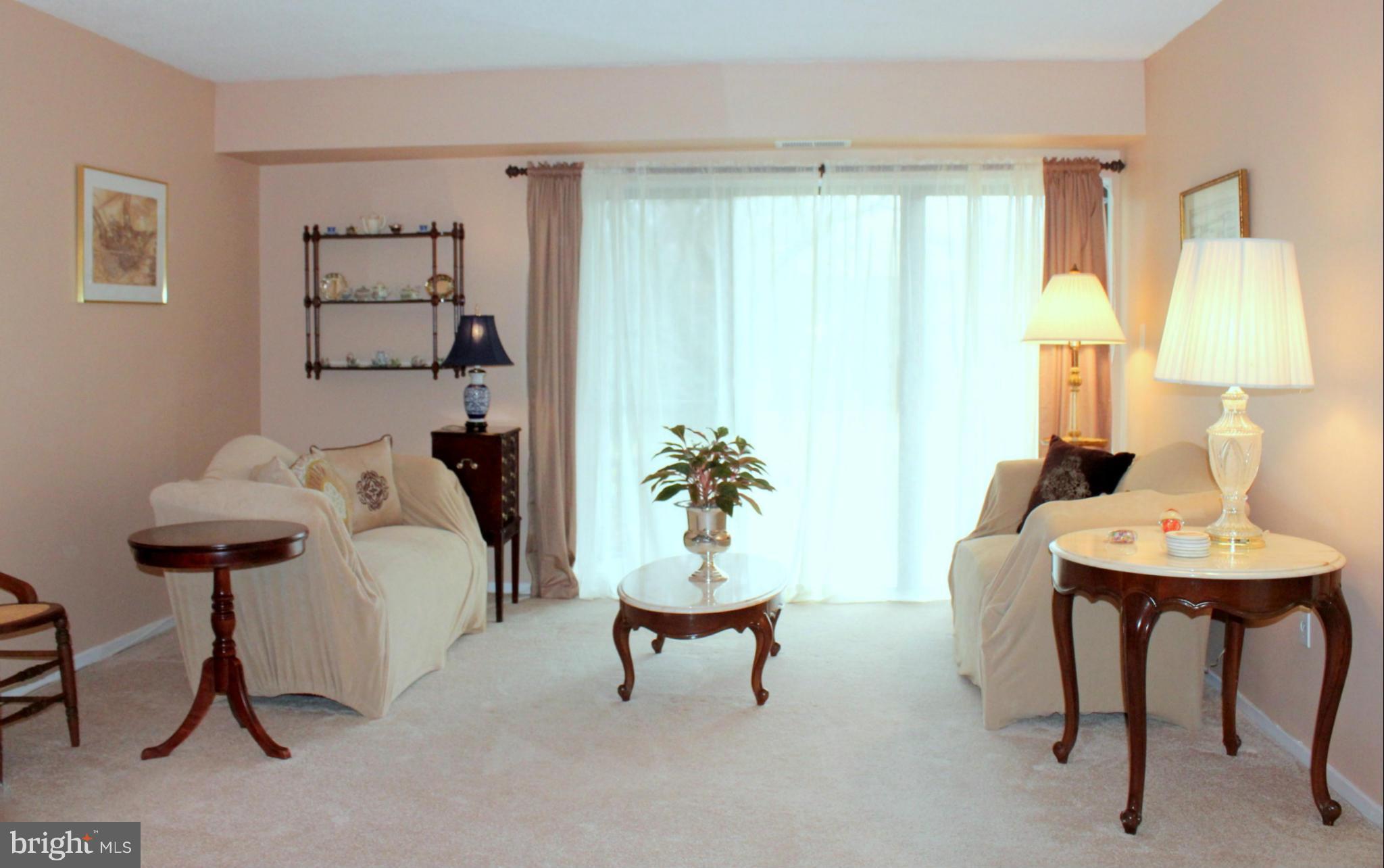5643 Harpers Farm Road, Unit A Columbia, MD 21044 - Photo 11 of 25 a living room with furniture and a table