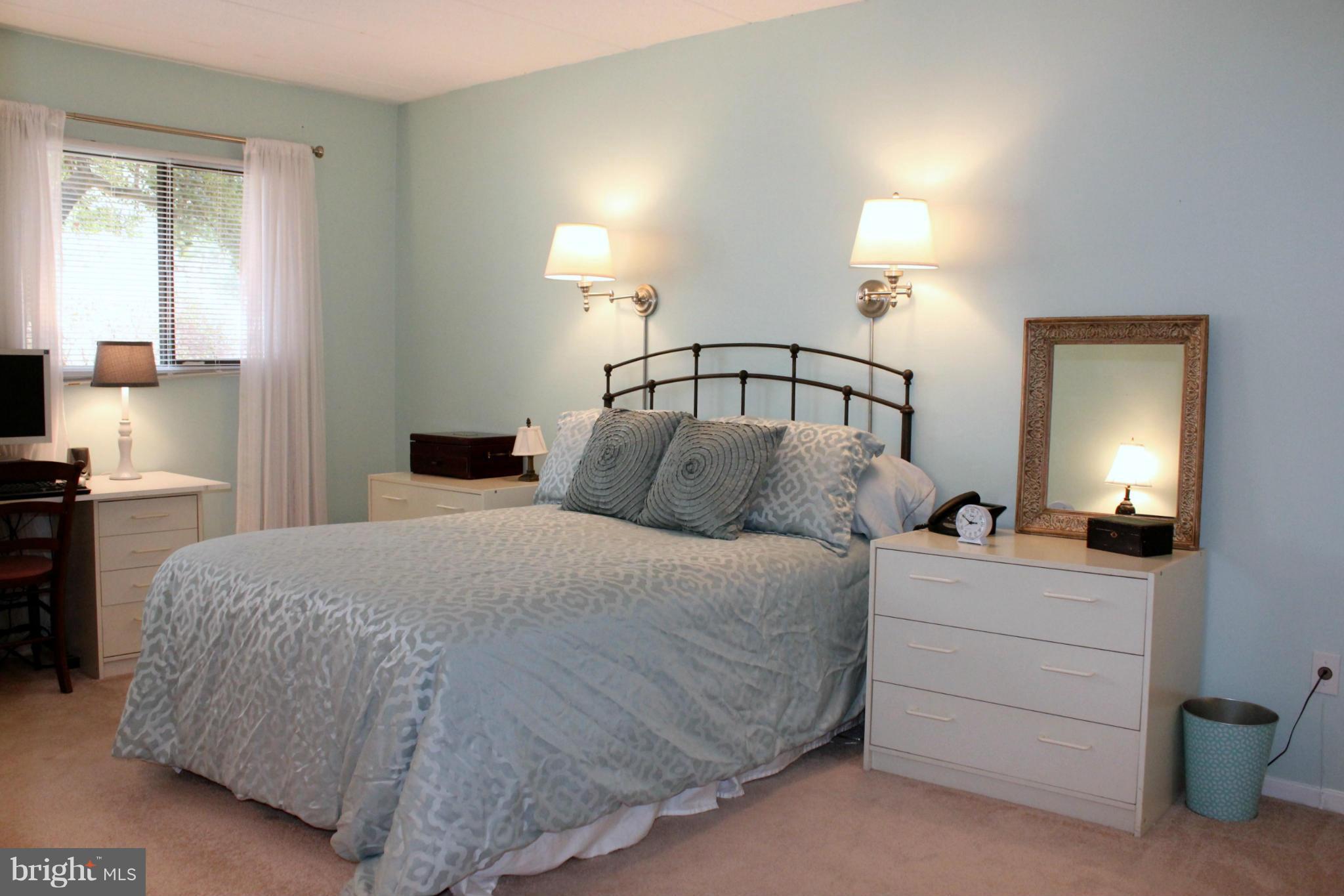 5643 Harpers Farm Road, Unit A Columbia, MD 21044 - Photo 15 of 25 a bedroom with a bed and a night stand