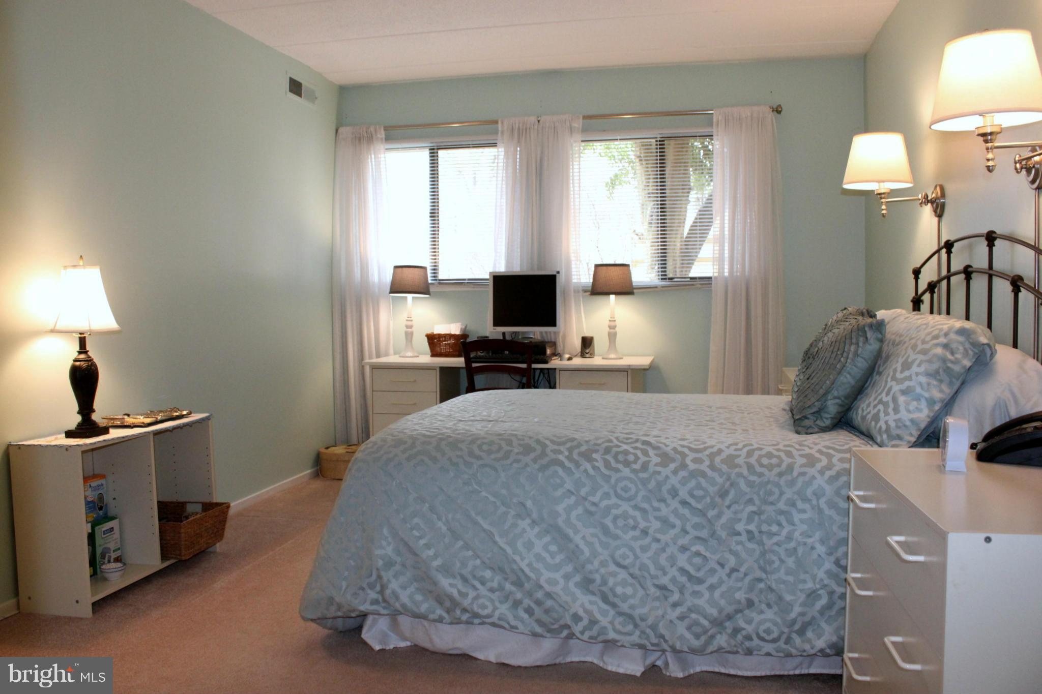 5643 Harpers Farm Road, Unit A Columbia, MD 21044 - Photo 16 of 25 a bedroom with a bed and a chandelier