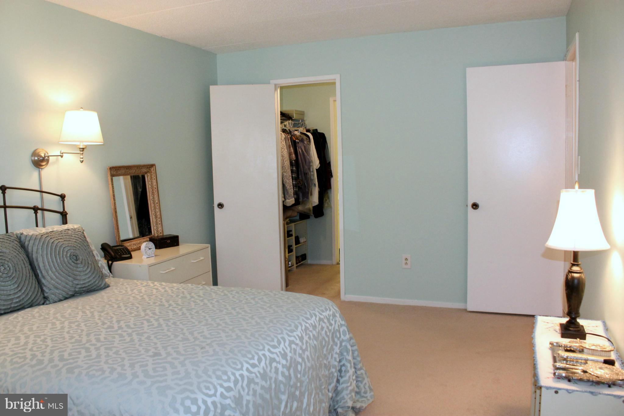 5643 Harpers Farm Road, Unit A Columbia, MD 21044 - Photo 17 of 25 a bedroom with a bed and a lamp